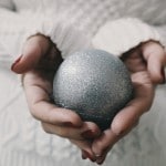 girl holding silver ornament